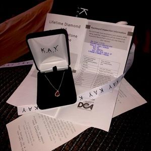A beautiful diamond birth stone necklace it’s January Garnet From Kay jewelers